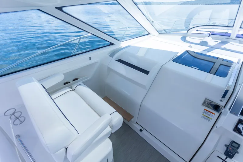 Slide: The Image of Interior of 2011 Sea Ray 450 Sundancer yacht with white seating and helm. - 20