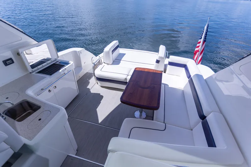 Slide: The Image of Luxurious 2011 Sea Ray 450 Sundancer yacht deck with seating and American flag. - 21
