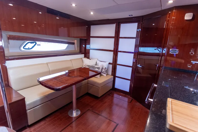 Slide: The Image of Luxurious interior of 2011 Sea Ray 450 Sundancer yacht with elegant seating and wooden finishes. - 29