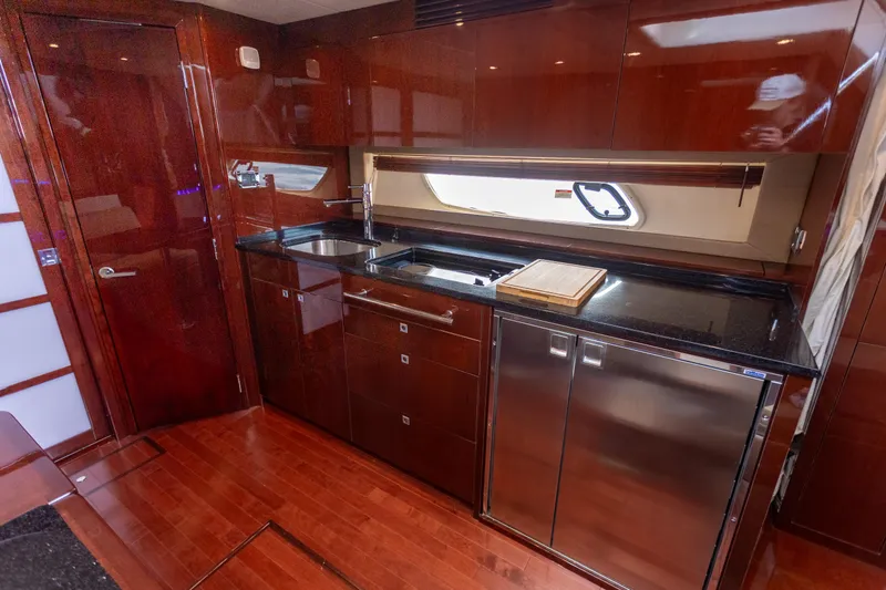 Slide: The Image of Luxurious kitchen interior of 2011 Sea Ray 450 Sundancer yacht with sleek cabinetry. - 32
