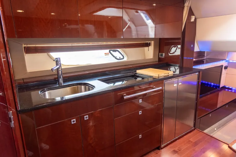 Slide: The Image of Luxurious kitchen interior of 2011 Sea Ray 450 Sundancer yacht with sleek cabinetry and modern appliances. - 33