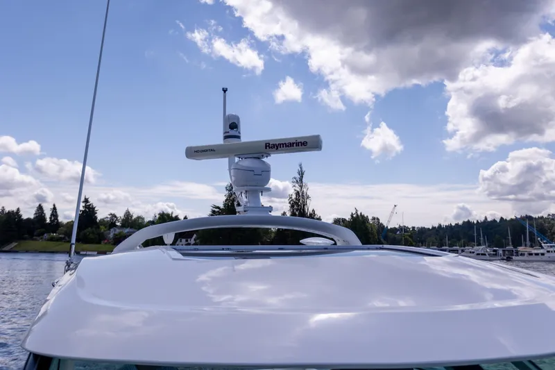 Slide: The Image of 2011 Sea Ray 450 Sundancer yacht with Raymarine radar, under a partly cloudy sky. - 44