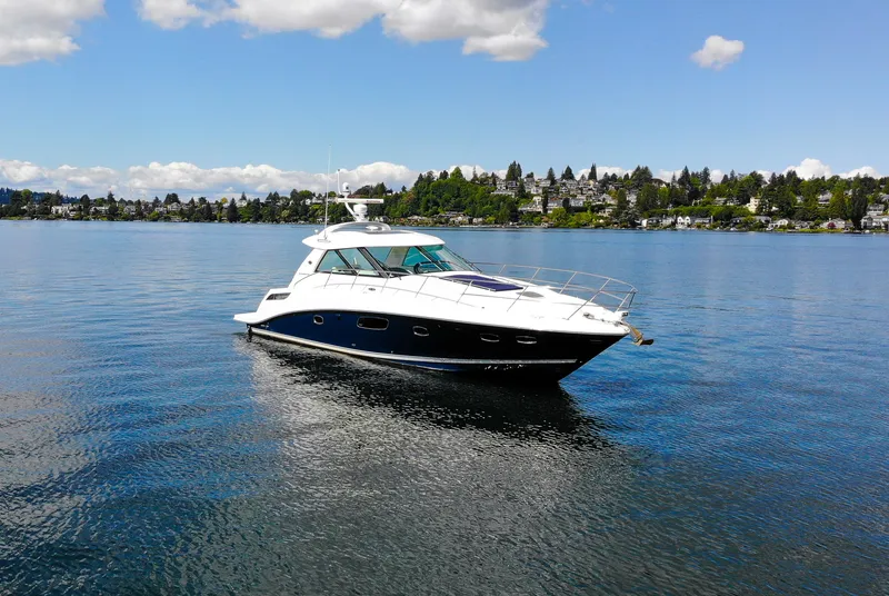Slide: The Image of 2011 Sea Ray 450 Sundancer yacht on calm water under a partly cloudy sky. - 6