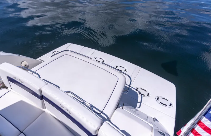 Slide: The Image of 2011 Sea Ray 450 Sundancer boat deck with seating, overlooking calm water. - 9