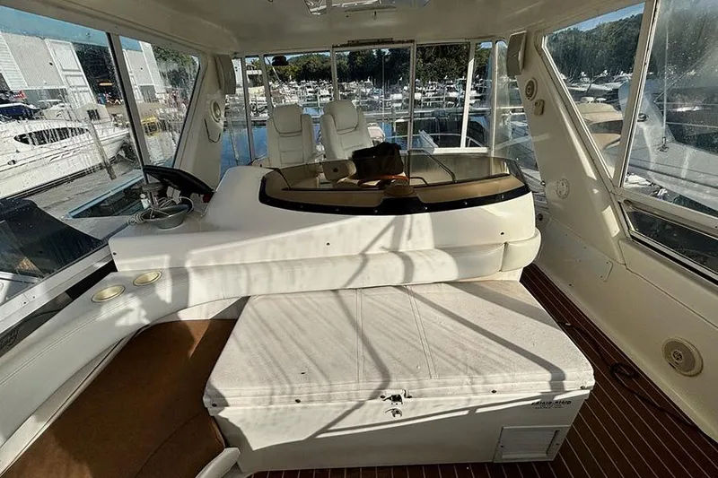 Slide: The Image of Interior view of 1998 Sea Ray 480 Sedan Bridge yacht with helm and seating area. - 11