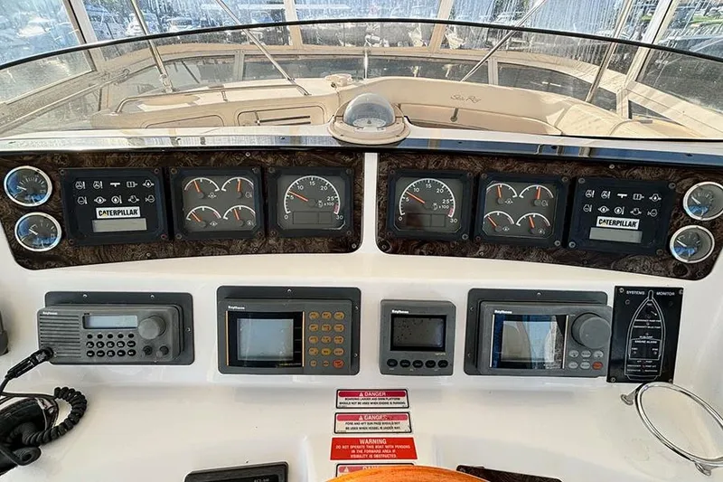 Slide: The Image of 1998 Sea Ray 480 Sedan Bridge dashboard with navigation and control instruments. - 15