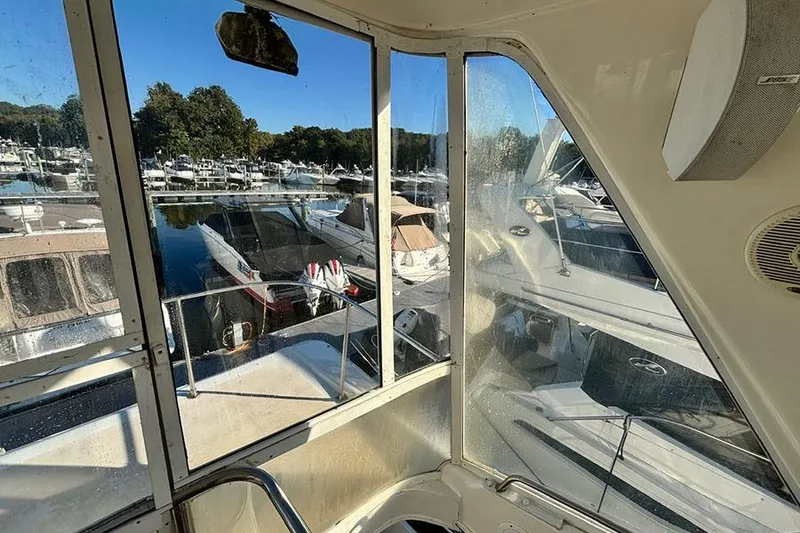 Slide: The Image of 1998 Sea Ray 480 Sedan Bridge view from cabin, overlooking marina with multiple boats. - 22