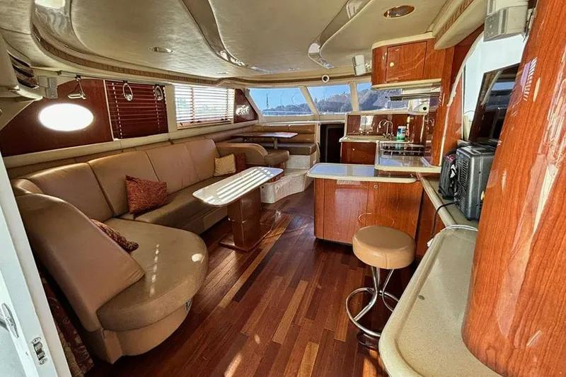 Slide: The Image of Luxurious interior of a 1998 Sea Ray 480 Sedan Bridge yacht with elegant wood finishes. - 23