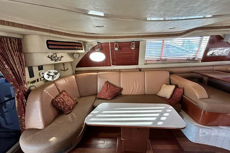 Slide: The Image of Luxurious interior of a 1998 Sea Ray 480 Sedan Bridge yacht with plush seating and elegant decor. - 24