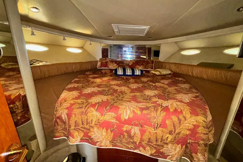 Slide: The Image of Luxurious bedroom interior of 1998 Sea Ray 480 Sedan Bridge yacht with tropical bedding. - 32