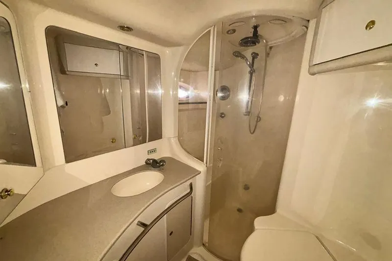 Slide: The Image of Luxurious bathroom in 1998 Sea Ray 480 Sedan Bridge yacht with shower and vanity. - 34