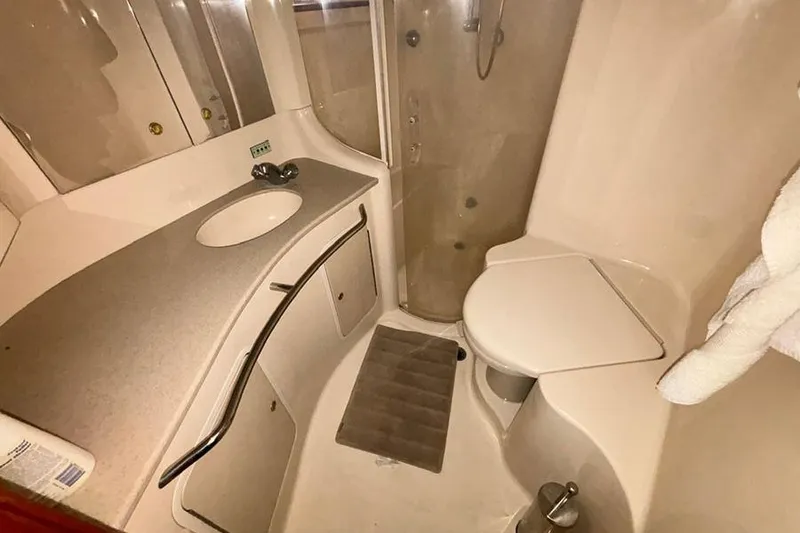 Slide: The Image of 1998 Sea Ray 480 Sedan Bridge bathroom with sink, shower, and toilet. - 35