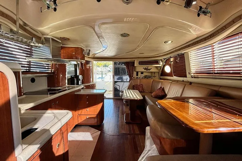 Slide: The Image of Luxurious interior of a 1998 Sea Ray 480 Sedan Bridge yacht with wood finishes. - 36
