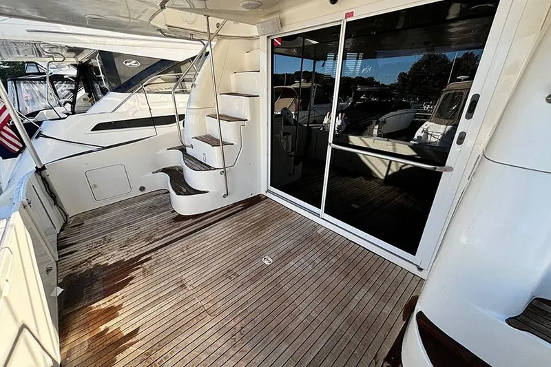Slide: The Image of 1998 Sea Ray 480 Sedan Bridge yacht with wooden deck and spiral staircase. - 7