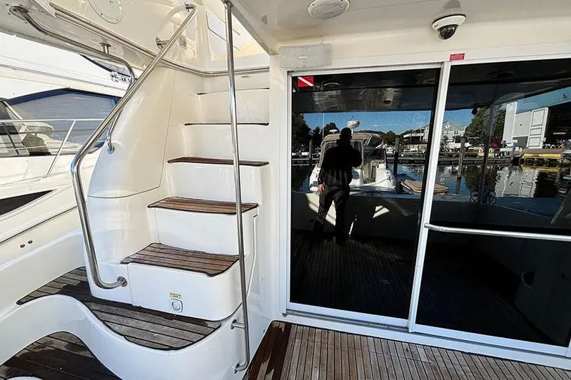 Slide: The Image of 1998 Sea Ray 480 Sedan Bridge yacht with elegant staircase and sliding glass door. - 9