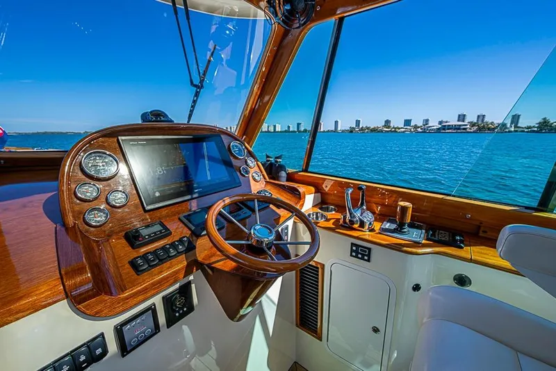Slide: The Image of 2016 Hinckley Picnic Boat MKIII helm with city skyline view. - 12
