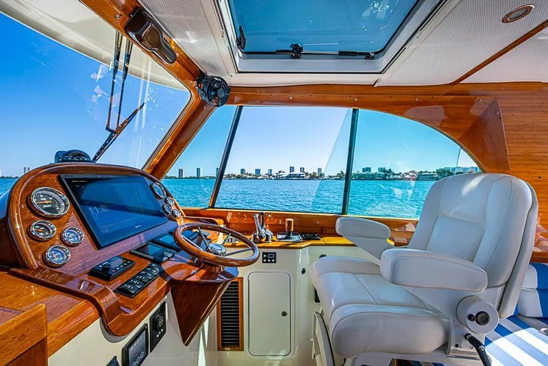 Slide: The Image of Interior of 2016 Hinckley Picnic Boat MKIII with luxurious helm and waterfront view. - 13