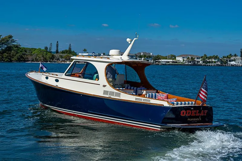 Slide: The Image of 2016 Hinckley Picnic Boat MKIII cruising on a sunny day, displaying American flag. - 2