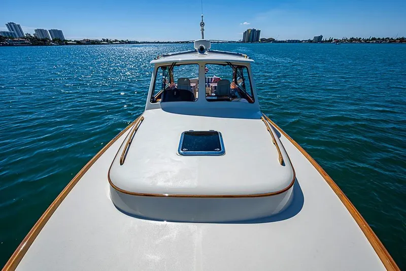 Slide: The Image of 2016 Hinckley Picnic Boat MKIII cruising on a sunny day, with city skyline in background. - 20