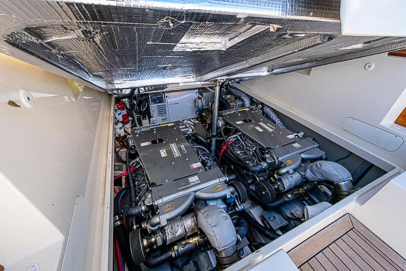 Slide: The Image of Engine compartment of 2016 Hinckley Picnic Boat MKIII, showcasing dual engines and mechanical components. - 23