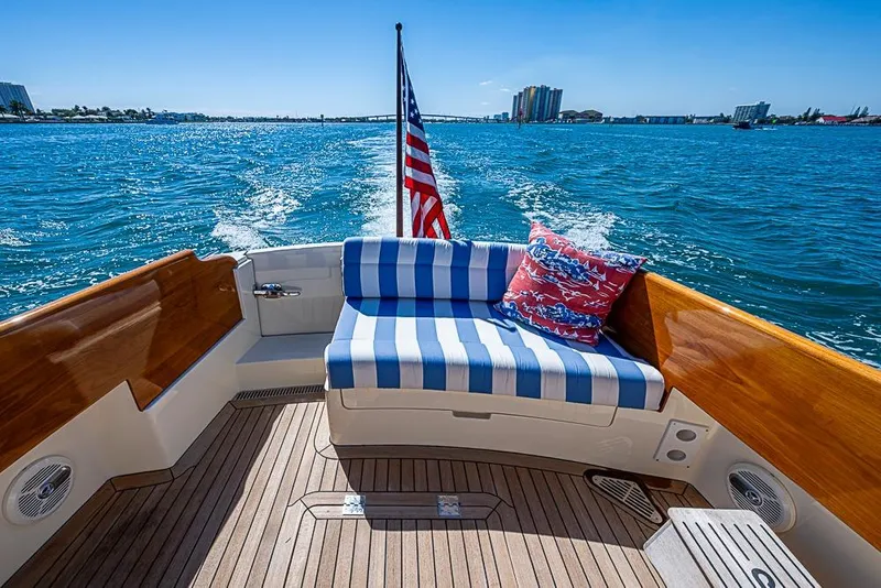Slide: The Image of 2016 Hinckley Picnic Boat MKIII cruising with striped seating and American flag. - 5