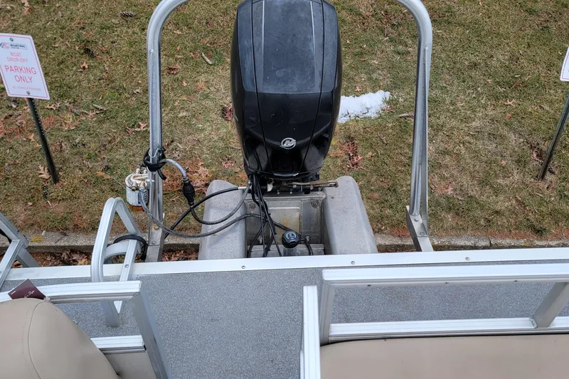 Slide: The Image of 2017 Sun Tracker Party Barge 24 DLX with outboard motor, parked on grass. - 13