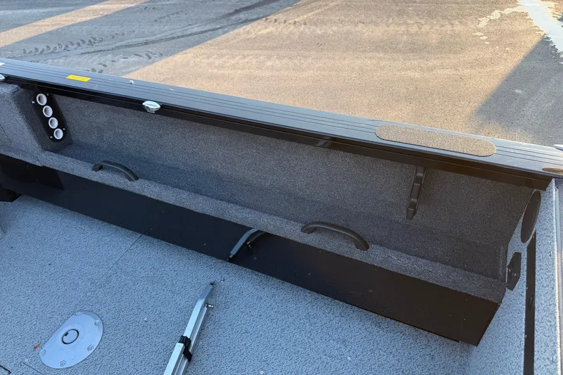 Slide: The Image of 2026 Crestliner 1850 Commander Elite boat interior with rod holders and storage compartments. - 11