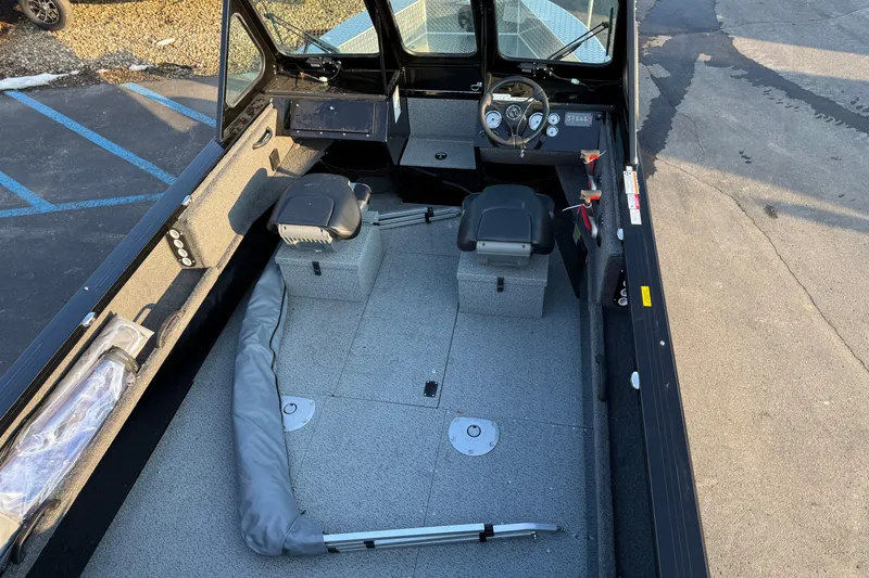 Slide: The Image of 2026 Crestliner 1850 Commander Elite boat interior with seating and steering console. - 12