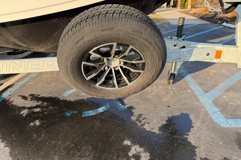 Slide: The Image of Trailer wheel of 2026 Crestliner 1850 Commander Elite boat in parking lot. - 16