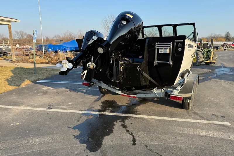 Slide: The Image of 2026 Crestliner 1850 Commander Elite boat on trailer, parked outdoors. - 3