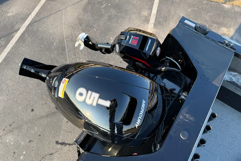 Slide: The Image of 2026 Crestliner 1850 Commander Elite with Mercury outboard motor in a parking lot. - 4