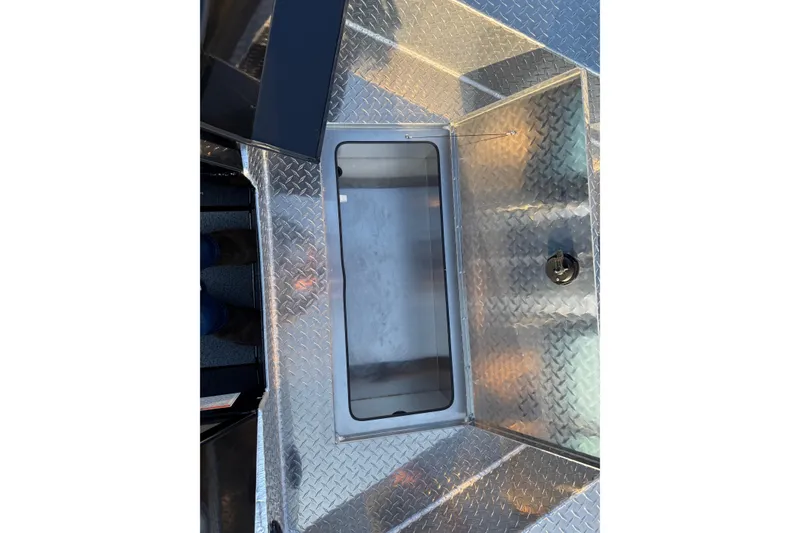 Slide: The Image of 2026 Crestliner 1850 Commander Elite boat with diamond plate flooring and storage compartment. - 7