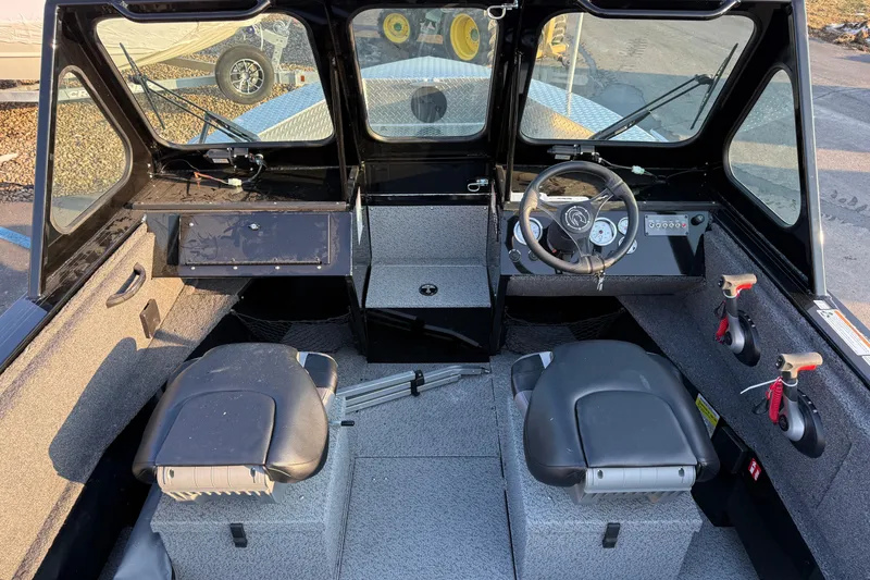 Slide: The Image of 2026 Crestliner 1850 Commander Elite boat interior with dual seats and steering console. - 8