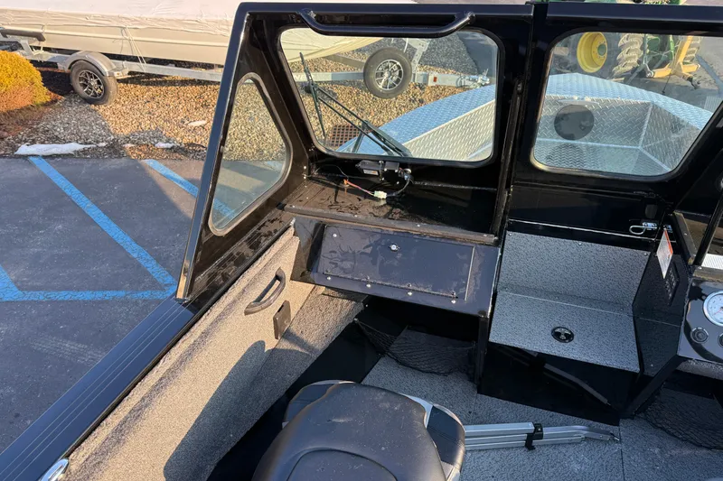 Slide: The Image of 2026 Crestliner 1850 Commander Elite boat interior with windshield and seating. - 9