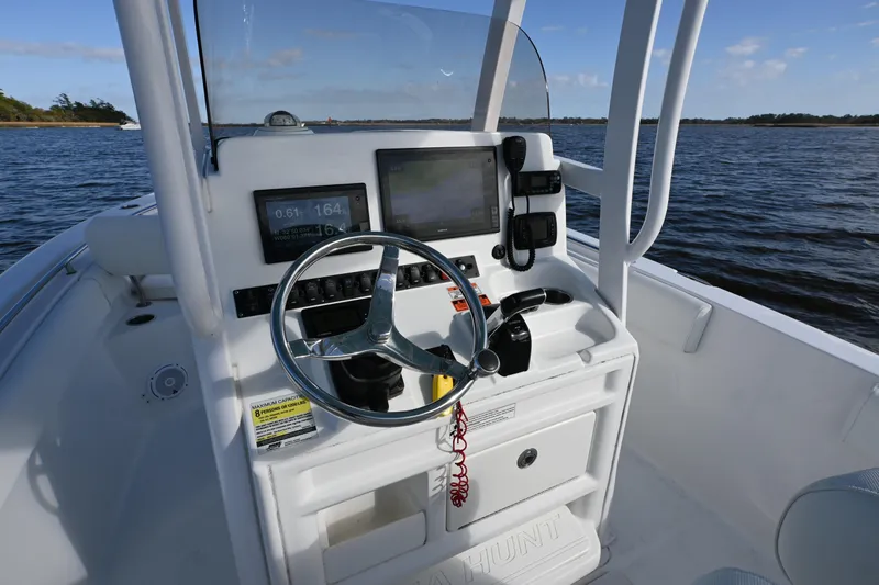 Slide: The Image of 2016 Sea Hunt Ultra 235 SE boat console with steering wheel and navigation equipment. - 12