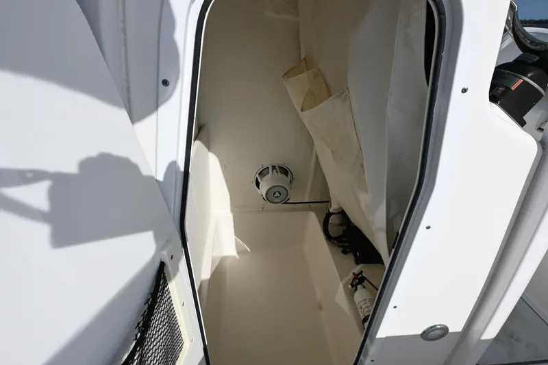 Slide: The Image of Interior of 2016 Sea Hunt Ultra 235 SE boat showing storage compartment and equipment. - 19