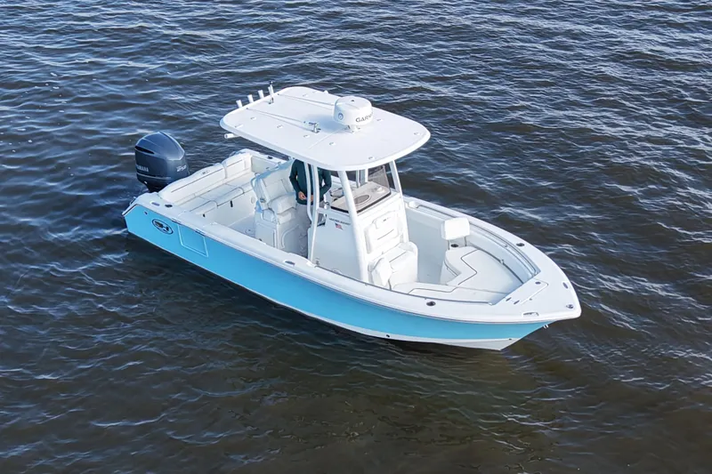 Slide: The Image of 2016 Sea Hunt Ultra 235 SE boat on open water, featuring sleek design and Yamaha engine. - 2