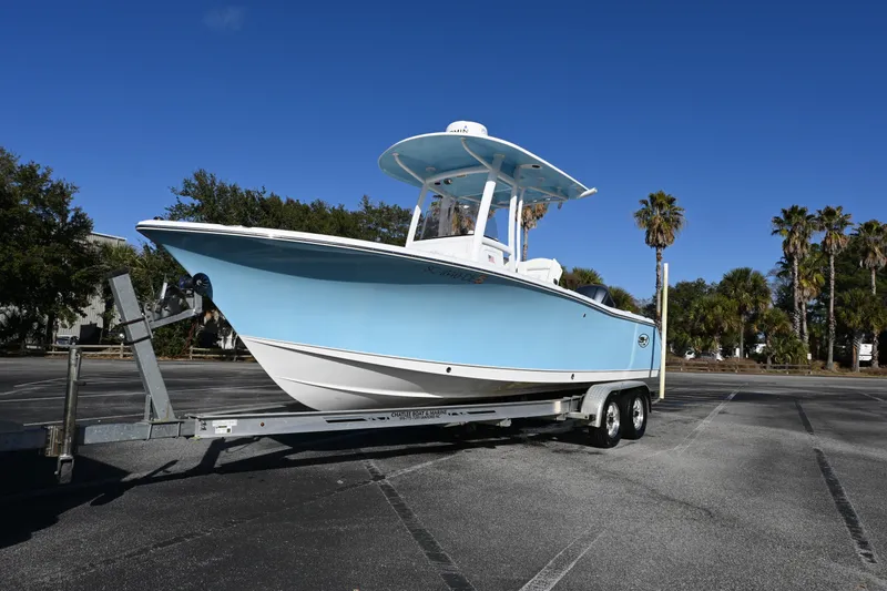 Slide: The Image of 2016 Sea Hunt Ultra 235 SE boat on trailer in sunny parking lot. - 22