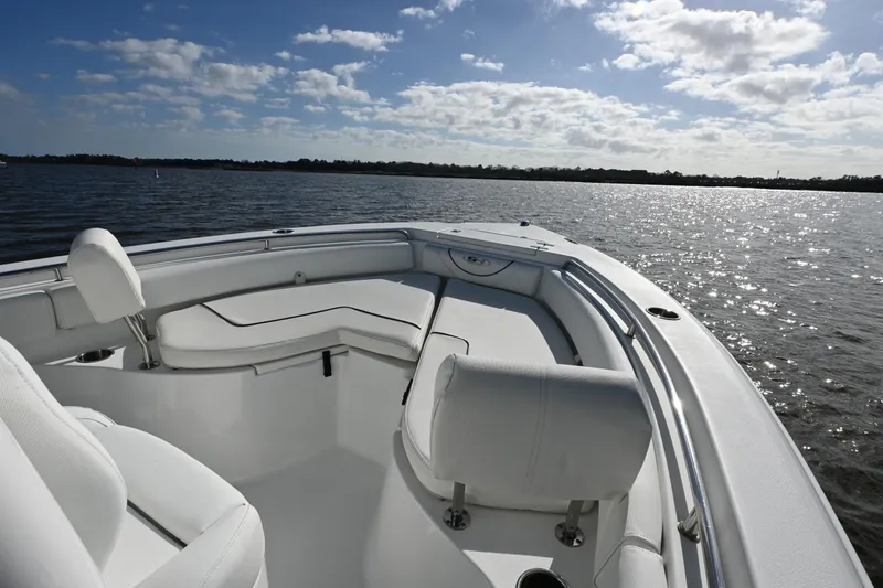 Slide: The Image of 2016 Sea Hunt Ultra 235 SE boat interior on a sunny day, overlooking calm waters. - 5