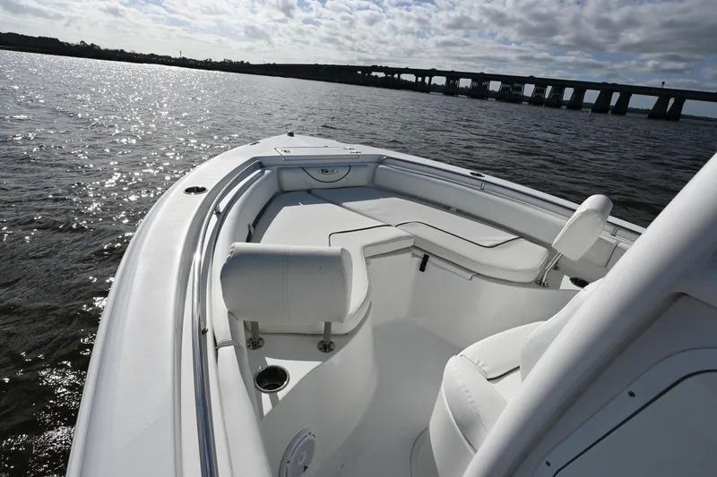 Slide: The Image of 2016 Sea Hunt Ultra 235 SE boat on water, featuring spacious seating and sleek design. - 6