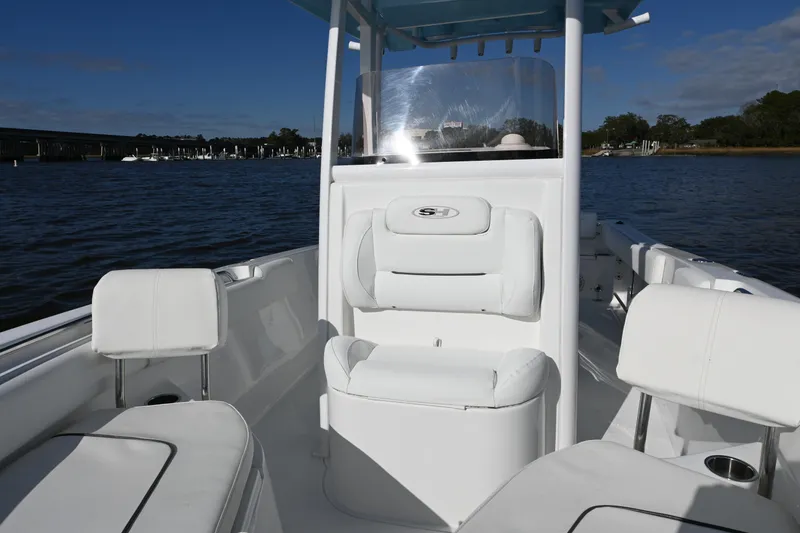 Slide: The Image of 2016 Sea Hunt Ultra 235 SE boat interior with white seating on water. - 7