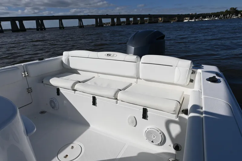 Slide: The Image of 2016 Sea Hunt Ultra 235 SE boat interior with white seating and water view. - 9