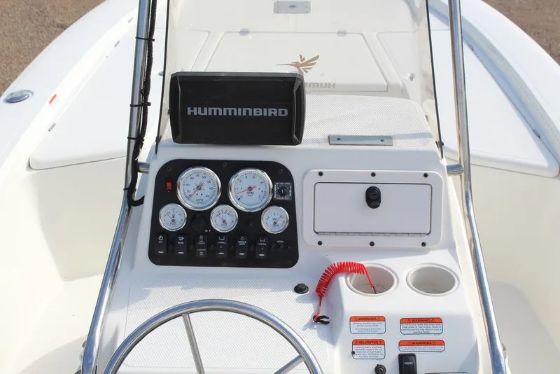 Slide: The Image of 2009 Kenner 2201 boat console with gauges, Humminbird device, and steering wheel. - 11