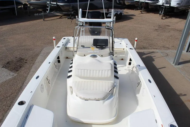 Slide: The Image of 2009 Kenner 2201 boat with white interior, parked in a marina. - 18