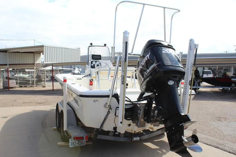 Slide: The Image of 2009 Kenner 2201 boat with Mercury engine on trailer, parked outdoors. - 4