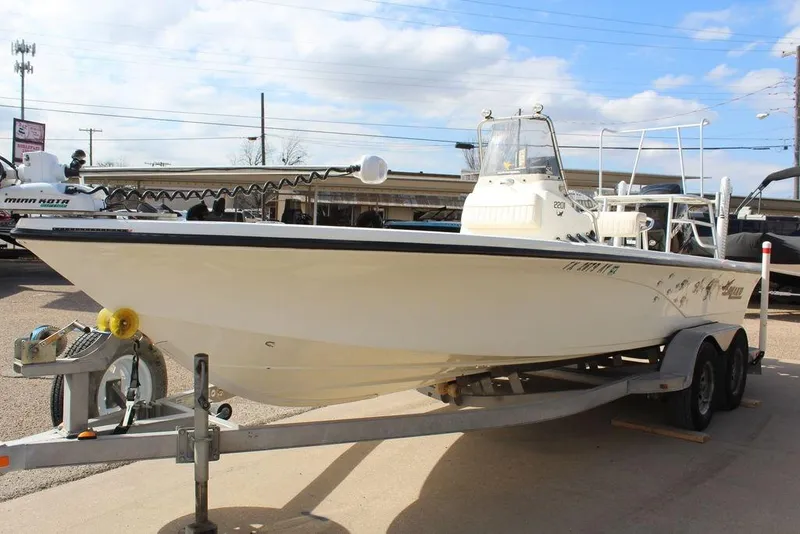 Slide: The Image of 2009 Kenner 2201 boat on trailer, featuring Minn Kota trolling motor, parked outdoors. - 6