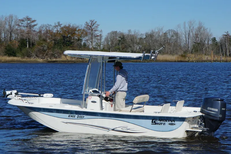 Slide: The Image of 2016 Carolina Skiff 198 DLV boat on water with person steering. - 16