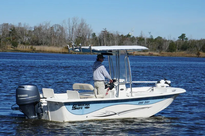 Slide: The Image of 2016 Carolina Skiff 198 DLV boat on water with Yamaha outboard motor. - 3