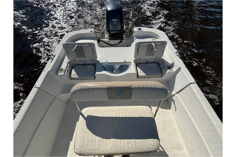 Slide: The Image of 2016 Carolina Skiff 198 DLV boat interior with Yamaha 90 engine on water. - 9