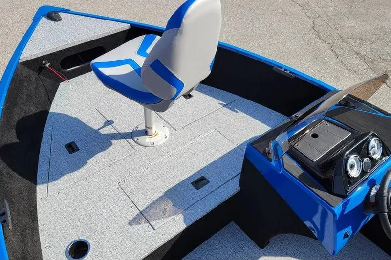 Slide: The Image of 2026 Smoker Craft Lazer 161 boat interior with blue and gray seating and dashboard. - 13